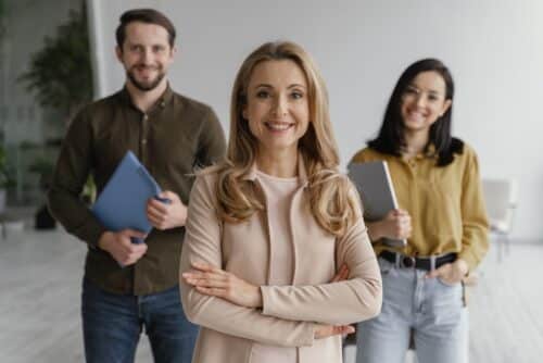 ferie non godute: figura HR che sorride di fronte a due dipendenti